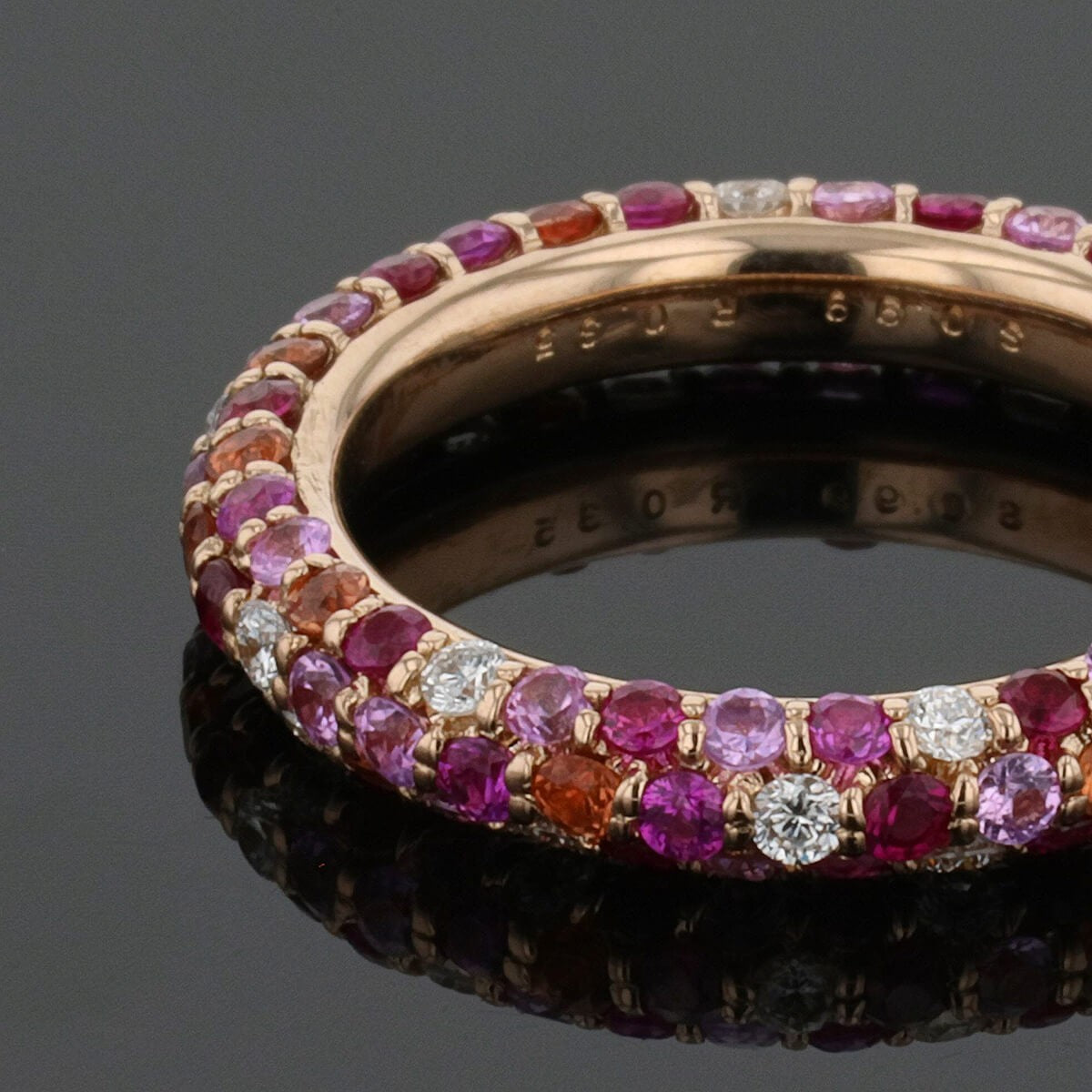 Diamonds, pink and orange sapphires, rubies and gold ring